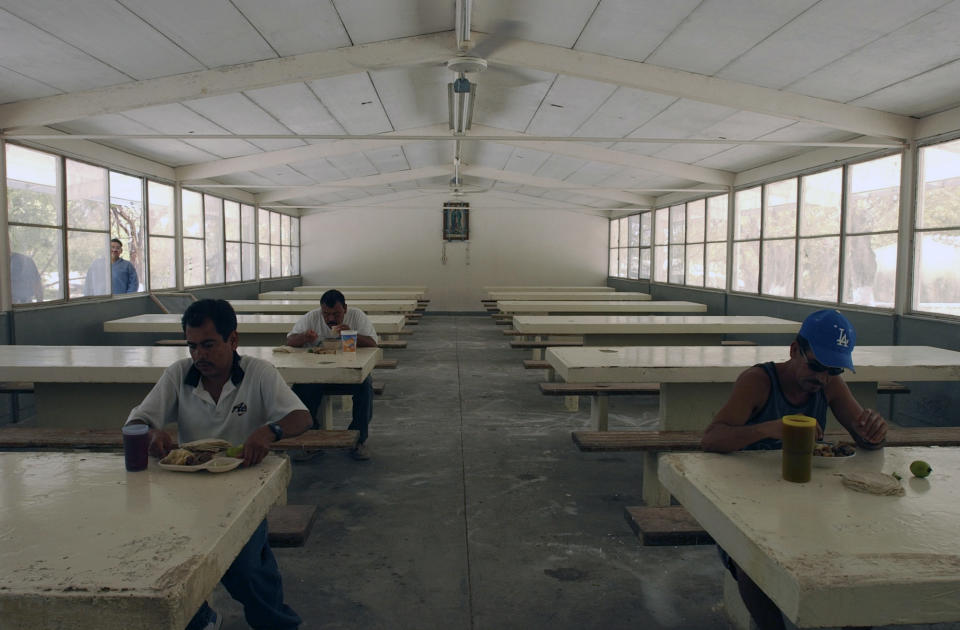 FILE - In this May 12, 2005 file photo, inmates have their meal in the mess hall at the Islas Marias federal prison island, located 90 miles south of Mazatlan, Mexico. President Andres Manuel Lopez Obrador said on Monday, Feb. 18, 2019 that he will close the famed island penal colony and will have it converted into a cultural and environmental education center. (AP Photo/Eduardo Verdugo, File)