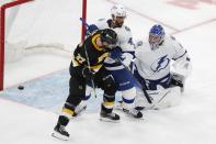 The puck goes wide as Tampa Bay Lightning's Pierre-Edouard Bellemare (41) defends against Boston Bruins' Patrice Bergeron (37) during the second period of an NHL hockey game, Saturday, Dec. 4, 2021, in Boston. (AP Photo/Michael Dwyer)