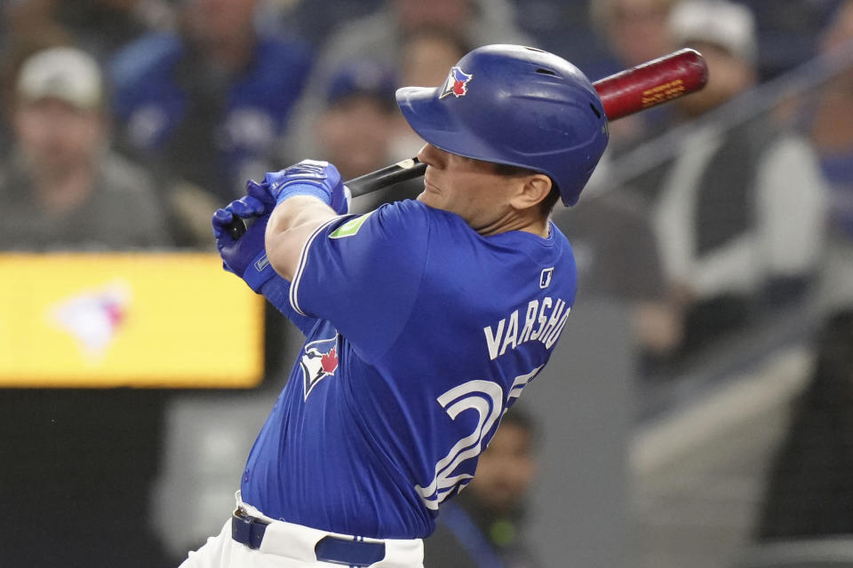 Toronto Blue Jays' Daulton Varsho hits a grand slam off Colorado Rockies pitcher Dakota Hudson during the first inning of a baseball game in Toronto, Saturday, April 13, 2024. (Chris Young/The Canadian Press via AP)