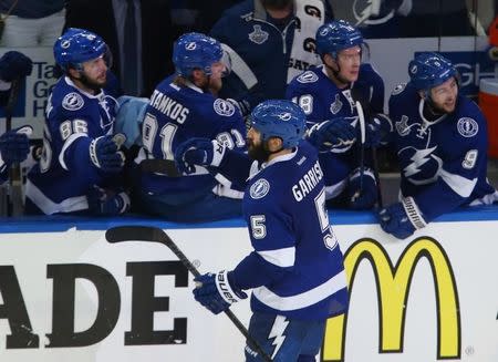 Jun 6, 2015; Tampa, FL, USA; Tampa Bay Lightning defenseman Jason Garrison (5) is congratulated by teammates after scoring a goal against the Chicago Blackhawks in the third period in game two of the 2015 Stanley Cup Final at Amalie Arena. Reinhold Matay-USA TODAY Sports