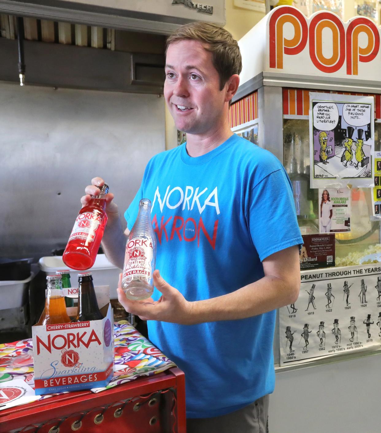 NORKA President Michael Considine talks about the progression of labeling on the soft drink bottles while visiting the Peanut Shoppe.