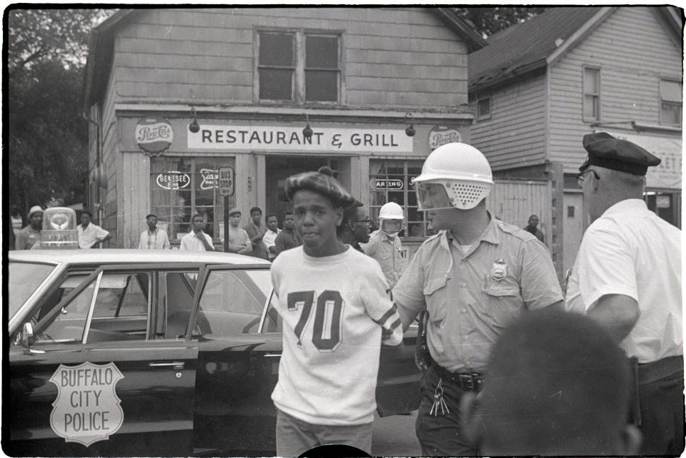 A Buffalo youth is led away after being arrested by police during the second night of protests in the city, June 28, 1967.<span class="copyright">Bettmann Archives/Getty Images</span>