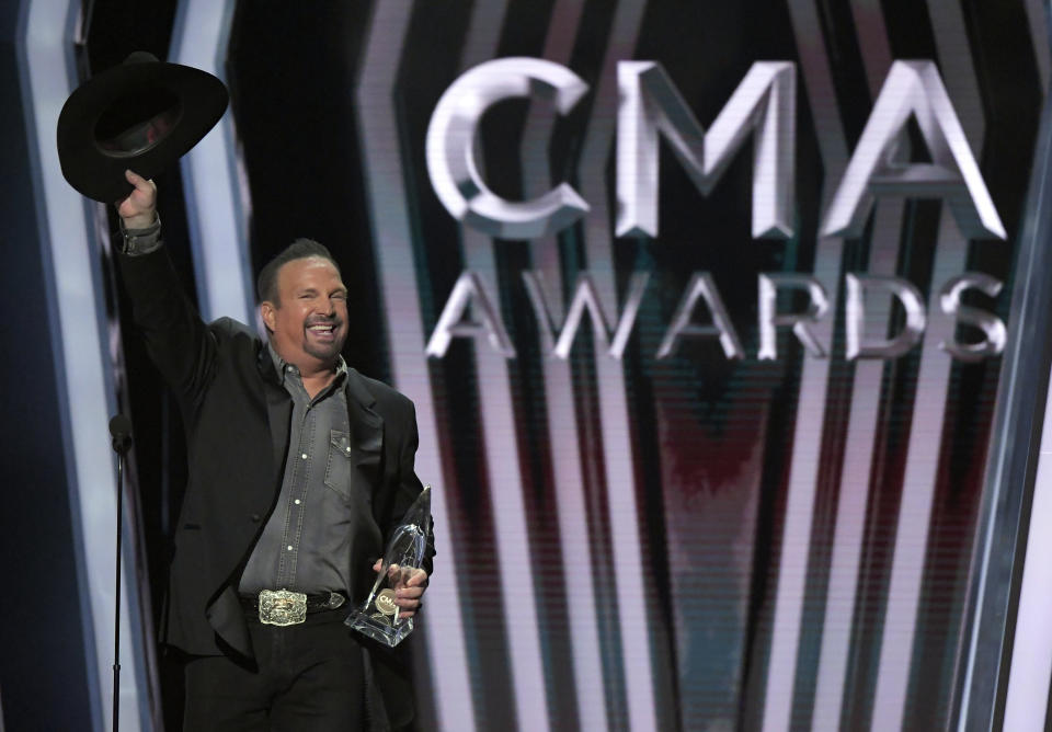 FILE - Garth Brooks accepts the award for entertainer of the year at the 53rd annual CMA Awards in Nashville, Tenn. on Nov. 13, 2019. Brooks says he is pulling himself out of nominations for the Country Music Association's entertainer of the year award, saying it's time for someone else to win the top prize. Brooks, who won the top prize last November, said during an online press conference on Wednesday that he doesn't want to be nominated in any upcoming years as well. (AP Photo/Mark J. Terrill, File)