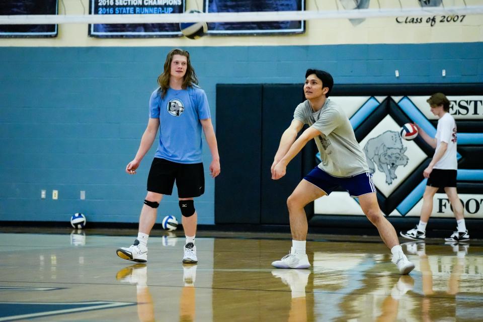 Outside hitter Ryan Bugs (right) passes during practice with the Estrella Foothills boys' volleyball team on March 27, 2023, in Goodyear, Ariz.