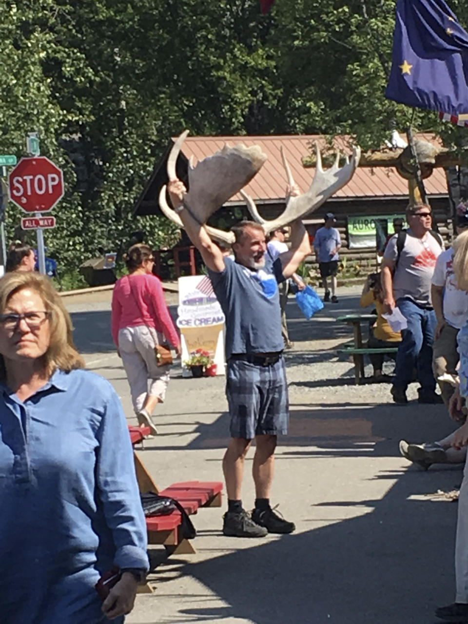 In this July 7, 2018, photo people browse a crowded Main Street in the tourist town of downtown Talkeetna, Alaska. This summer, streets are pretty quiet in Talkeetna after most major cruise ship companies canceled their summer tourist seasons due to the coronavirus pandemic. As a result nearly half of Alaska's annual 2.2 million visitors won't be visiting the nation's northernmost state. (AP Photo/Mark Thiessen)