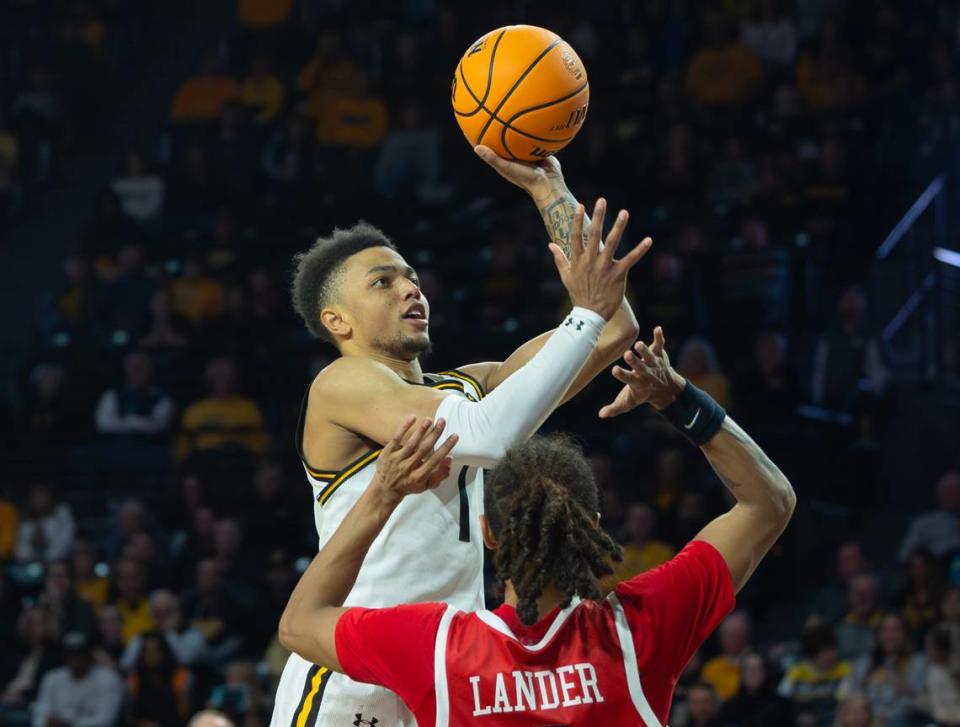 Wichita State’s Xavier Bell shoots the ball over Western Kentucky’s Khristian Lander during the second half of their game at Koch Arena on Thursday night. Travis Heying/The Wichita Eagle