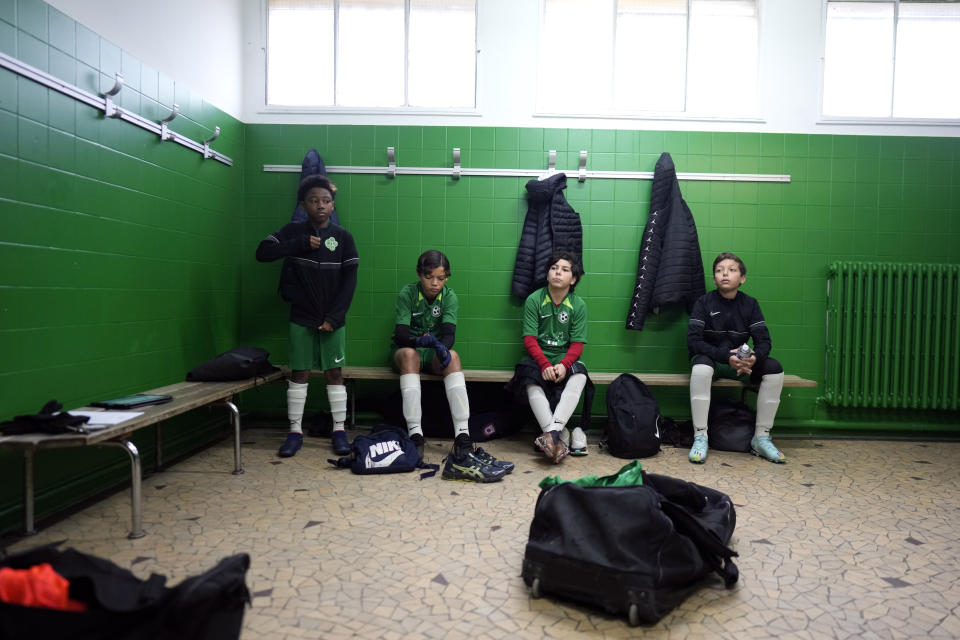 Players of the football club AS Bondy, where Kylian Mbappe played as a kid, prior to a match on the Leo Lagrange stadium in Bondy, east of Paris, Saturday, Dec. 17, 2022. On the football fields where Kylian Mbappe hones the feints, dribbles and shots that all of France hopes to see in Sunday's World Cup final against Argentine, the next generation of French kids with big dreams is already hard at work to follow in the superstar's footsteps. (AP Photo/Thibault Camus)