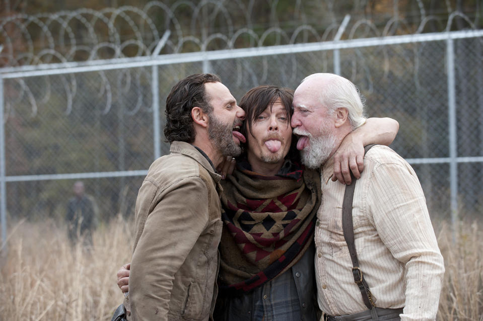 <p>Andy Lincoln and Norman Reedus give a Reedus-type salute with fan and cast favorite Scott Wilson on the prison set.<br><br>(Photo: AMC) </p>