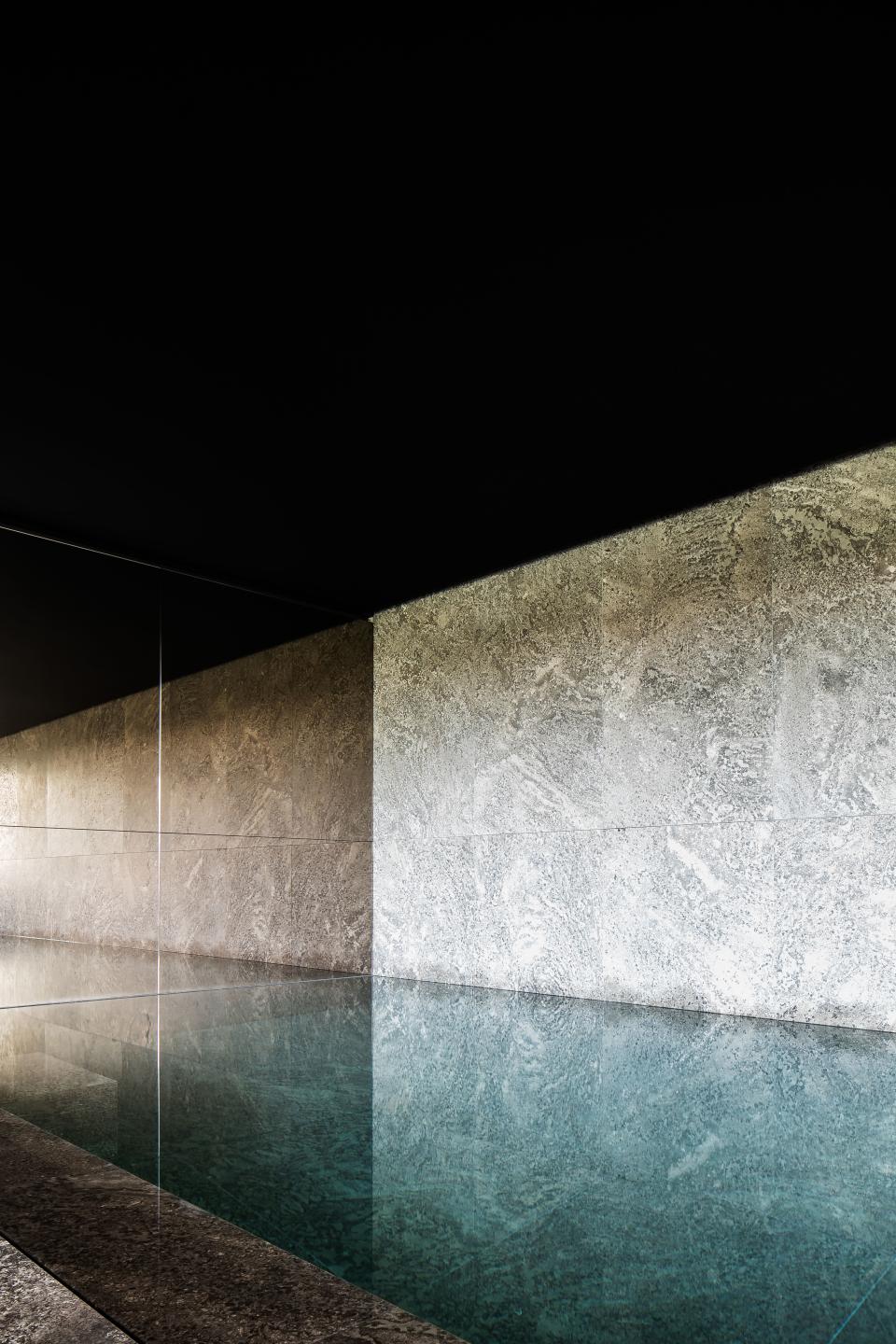 This mesmerizing pool inside a private spa by Britsom & Philips in Gent, Belgium, features a wall and basin made of Muschelkalk marble from Germany. “By using perpendicular instead of lengthwise cuts to divide the large blocks into smaller ones, an irregular pattern was obtained,” writes Demeulemeester. “The slabs were first sandblasted to make their pores deeper and then brushed to make their surface softer to the touch.”