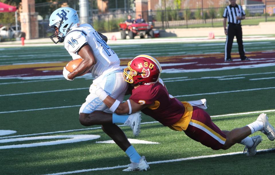 Northern State defensive back Lynden Williams tackles Upper Iowa wide receiver Jahani Wright in the first half of the Wolves' 30-0 Northern Sun Intercollegiate Conference victory Thursday night at Dacotah Bank Stadium.