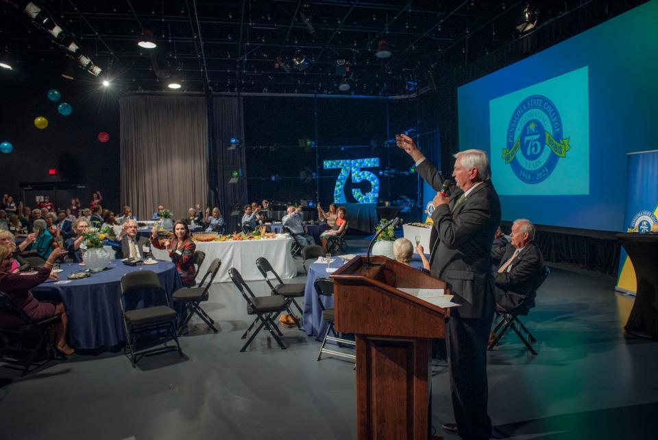 Pensacola State College President Ed Meadows raises a toast in honor of the college's 75 year anniversary during a celebration Sept. 13, 2023, at the Jean and Paul Amos Performance Studio.