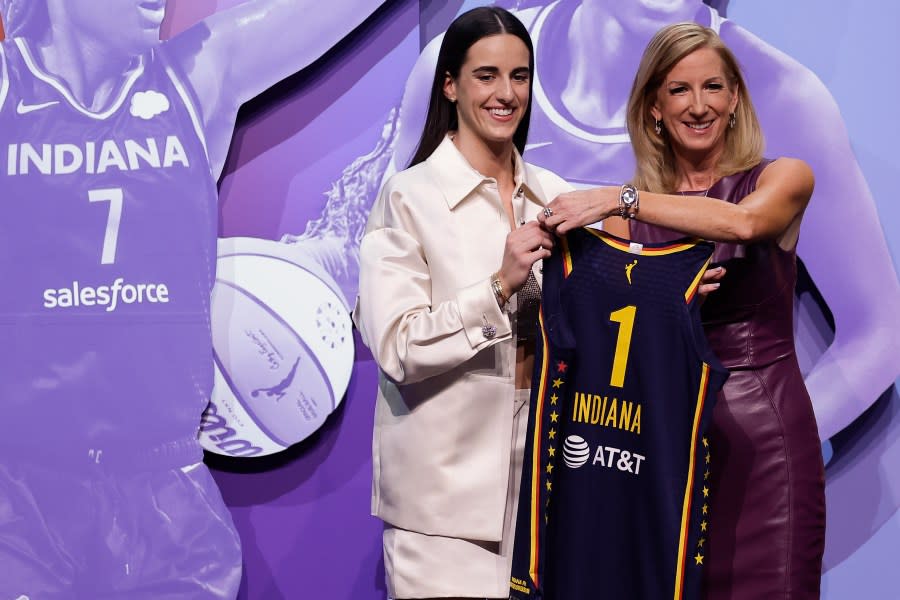 Iowa’s Caitlin Clark, left, poses for a photo with WNBA commissioner Cathy Engelbert, right, after being selected first overall by the Indiana Fever during the first round of the WNBA basketball draft, Monday, April 15, 2024, in New York. (AP Photo/Adam Hunger)