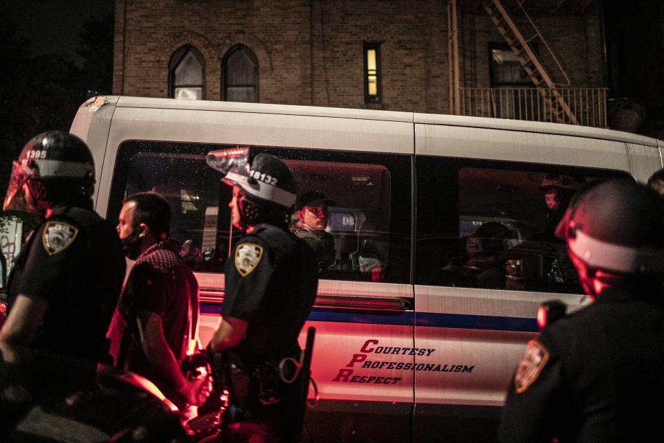 Protesters are taken away in a police van after they were arrested for breaking a curfew during a solidarity rally calling for justice over the death of George Floyd, Friday, June 5, 2020, in the Brooklyn borough of New York. Floyd, an African American man, died on May 25 after a white Minneapolis police officer pressed a knee into his neck for several minutes even after he stopped moving and pleading for air. (AP Photo/Wong Maye-E)