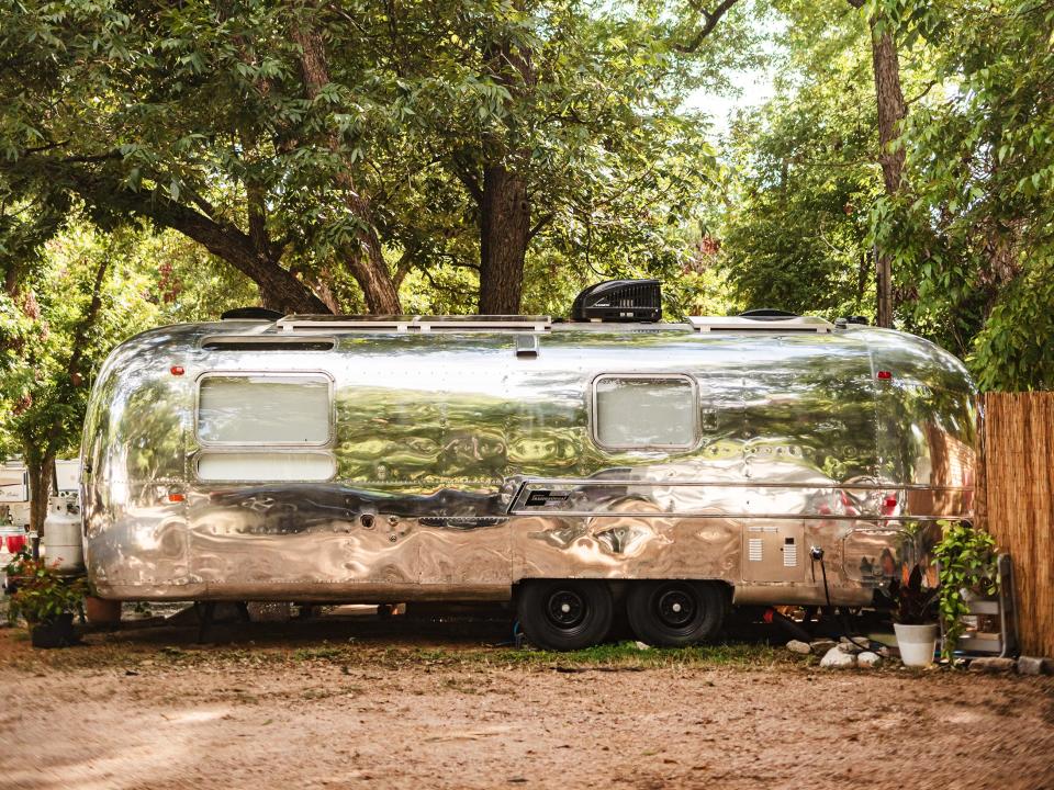 The converted Airstream has a shiny, reflective surface.