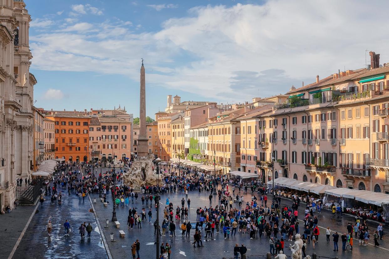 Crowds of people in a piazza in Roma, Italy