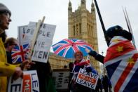 Pro- and ant- Brexit demonstrators protested outside Parliament as May announced the postponement of the vote on her Brexit agreement