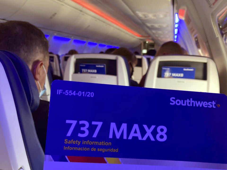 FILE - Passengers on a Southwest Airlines Boeing 737 MAX 8 flight prepare to land at Houston's Hobby airport, March 20, 2021. A federal judge has ordered Boeing Co. to be arraigned on a felony charge stemming from crashes of two 737 Max jets, a ruling that threatens to unravel an agreement Boeing negotiated to avoid prosecution. (AP Photo/Charlie Riedel, File)