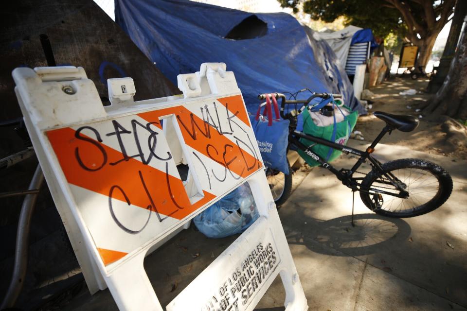 Tents and a bike sit on 1st Street between Spring and Broadway in L.A.