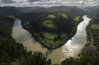 The lower reaches of the Whanganui River flow near the Kaiwhaiki settlement in New Zealand on June 15, 2022. Gerrard Albert, the lead negotiator for Whanganui Maori in getting the river’s personhood recognized by lawmakers, says the status is a legal fiction, a construct more commonly used to give something like a corporation legal standing. (AP Photo/Brett Phibbs)