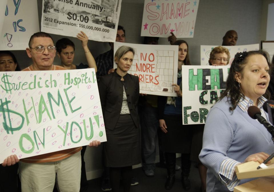 Ramona Ortiz-Patino, right, one of two former patients of Swedish Covenant Hospital who are now plaintiffs in a lawsuit against the health care facility speaks at a news conference Thursday, Nov. 29, 2012 in Chicago. The lawsuit claims that the nonprofit hospital failed to provide charity care to low-income uninsured patients which is required by law in exchange for state tax break benefits. (AP Photo/M. Spencer Green)