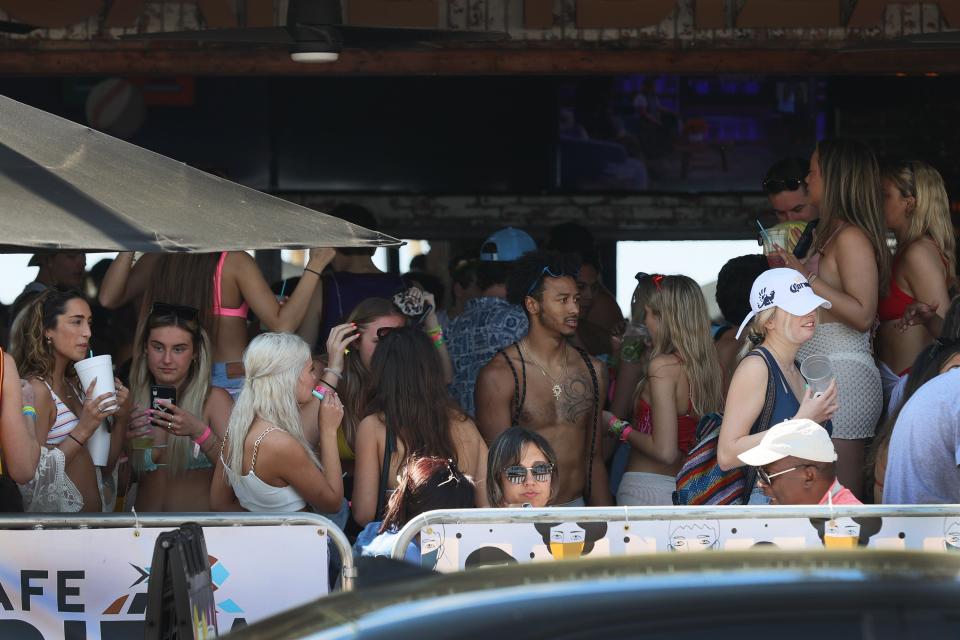 Young people without masks pack into Cafe Ibiza, a bar in Fort Lauderdale, on March 4, 2021Getty Images