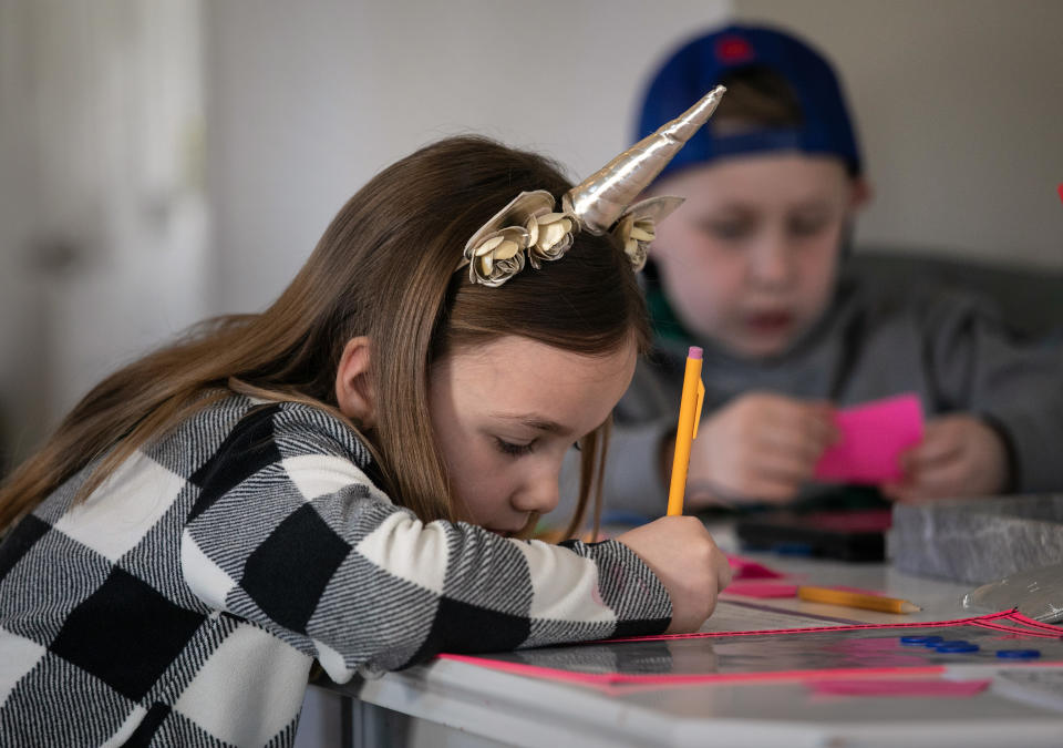 NEW ROCHELLE,  - MARCH 18: Nola Eaton, 6, and her brother Cam, 9, take part in home schooling on March 18, 2020 in New Rochelle, New York. Schools in New Rochelle, a hot spot in the U.S. for the coronavirus (COVID-19) pandemic, were suspended on March 13, and parents have been tasked with carrying out distance learning programs at home. Nola's mother, Farrah Eaton, a former high school administrator, said she plans to hold sessions with her three children from 9am-12pm Monday-Friday.  (Photo by John Moore/Getty Images)