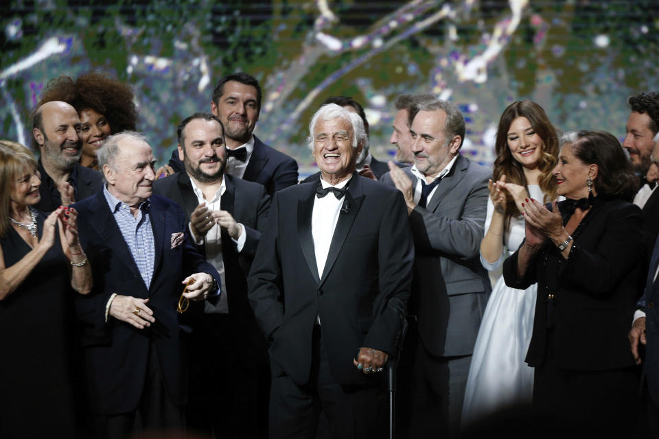 FILE - In this Feb. 24, 2017 file photo, French actor Jean-Paul Belmondo, center, is congratulated by actors on stage during the ceremony of the 42nd Cesar Film Awards, at the Salle Pleyel, in Paris. French New Wave actor Jean-Paul Belmondo has died, according to his lawyer’s office on Monday Sept. 6, 2021. (AP Photo/Thibault Camus, File)
