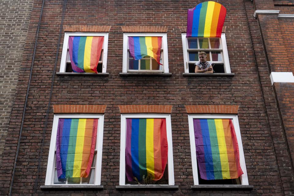 Rainbow flags cover a set of windows in Soho as Members of the Lesbian, Gay, Bisexual and Transgender (LGBT) community hold the annual Pride Parade in London on July 6, 2019.