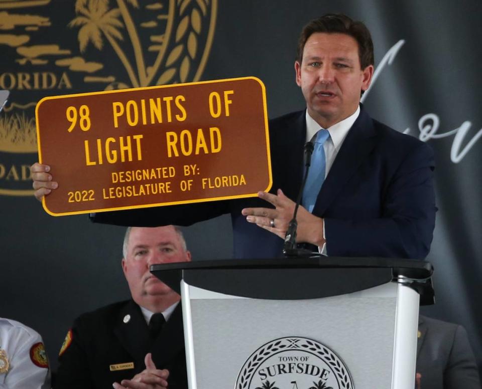 Florida Governor Ron DeSantis reveals a road sign honoring the memory of the lives lost during a public memorial event on Friday, June 24, 2022, to mark the one-year anniversary of the collapse of Champlain Towers South in Surfside, Florida.