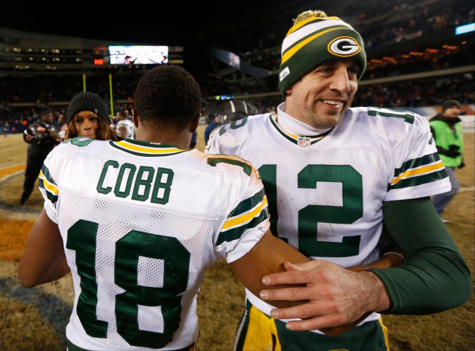 Green Bay Packers quarterback Aaron Rodgers (12) celebrates with wide receiver Randall Cobb (18) after an NFL football game against the Chicago Bears, Sunday, Dec. 29, 2013, in Chicago. Cobb made the game-winning touchdown reception in the Packers' 33-28 win to capture the NFC North title.