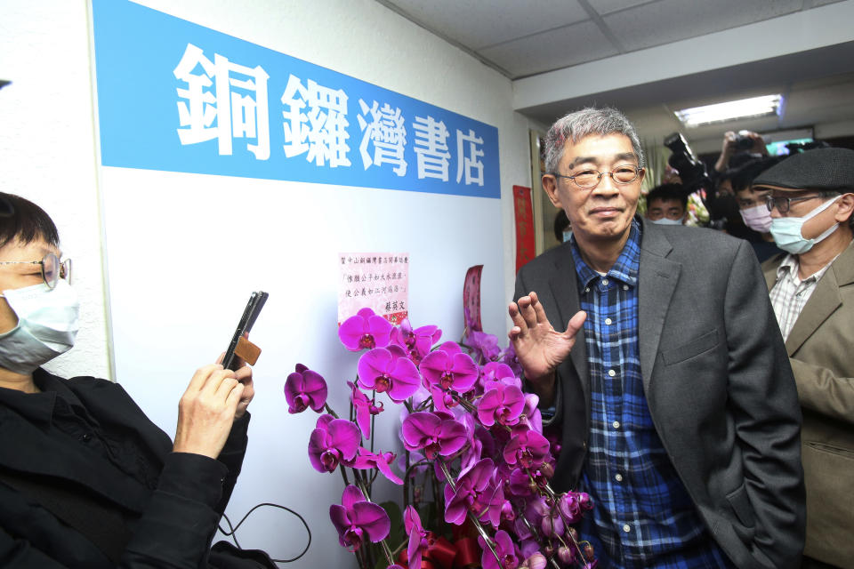 Lam Wing-kee, one of five shareholders and staff at the Causeway Bay Book shop in Hong Kong, waves to the press at his new book shop on the opening day in Taipei, Taiwan, Saturday, April 25, 2020. The part-owner of the Hong Kong bookstore specializing in texts critical of China’s leaders reopened his shop in Taiwan on Saturday after fleeing Hong Kong due to legal troubles, saying he was grateful for the opportunity to make China's Communist rulers “less than happy." (AP Photo/Chiang Ying-ying)