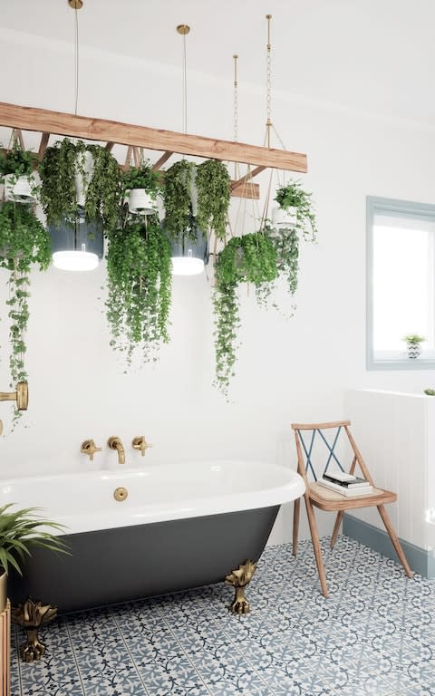 Plants are hung from a ladder in this bathroom. Pugin Filigree floor tiles, £64 per square metre, British Ceramic Tile (britishceramictile.com)