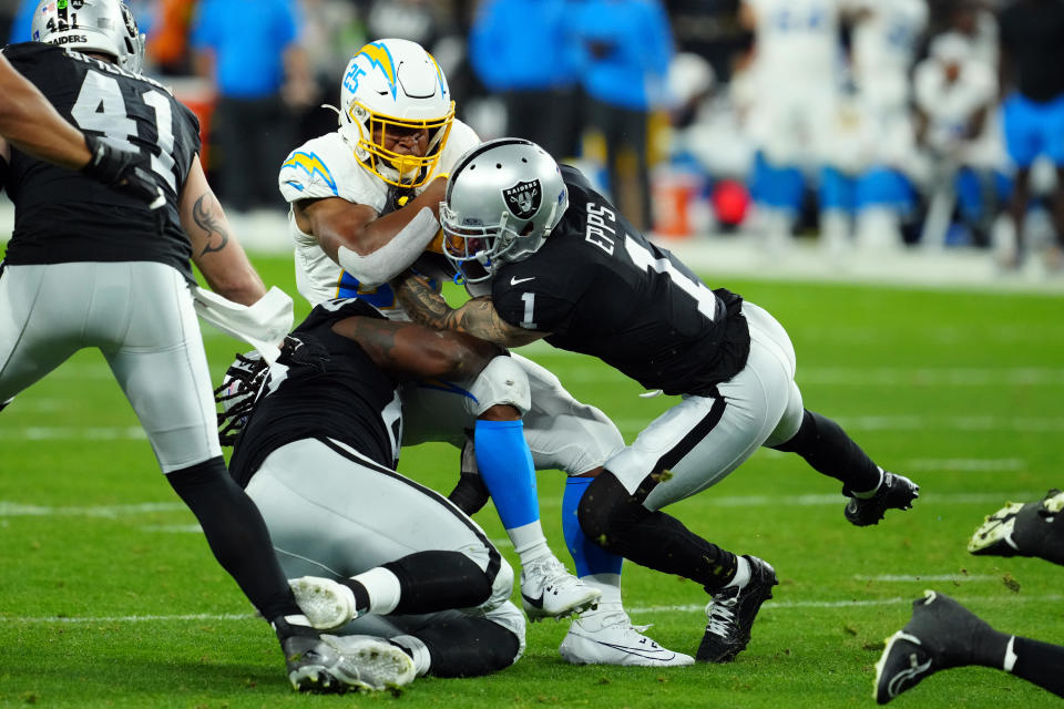 Dec 14, 2023; Paradise, Nevada, USA; Las Vegas Raiders safety Marcus Epps (1) tackles Los Angeles Chargers running back <a class="link " href="https://sports.yahoo.com/nfl/players/32782" data-i13n="sec:content-canvas;subsec:anchor_text;elm:context_link" data-ylk="slk:Joshua Kelley;sec:content-canvas;subsec:anchor_text;elm:context_link;itc:0">Joshua Kelley</a> (25) in the first quarter at Allegiant Stadium. Mandatory Credit: Stephen R. Sylvanie-USA TODAY Sports