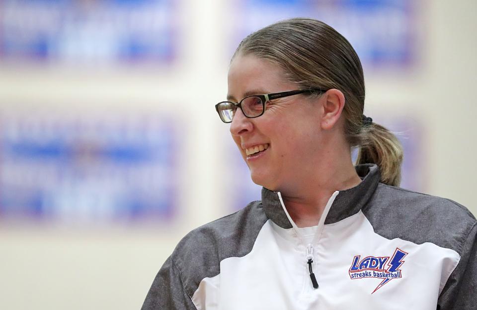 Lake girls basketball coach Ashley Komo watches her girls take on the Green Bulldogs during the first half of a basketball game, Wednesday, Jan. 25, 2023, in Uniontown, Ohio.