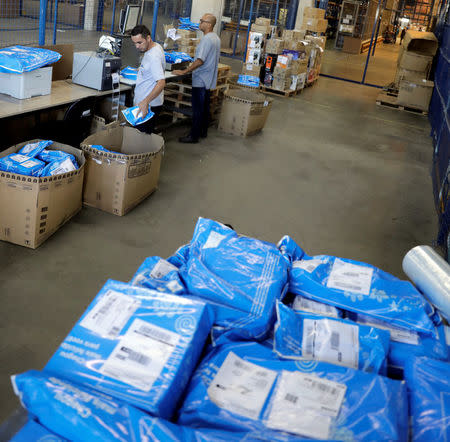 Employees prepare merchandise sold via eCommerce to be delivered to customers at retail chain Magazine Luiza S.A logistics center in Louveira, Brazil April 24, 2018. REUTERS/Paulo Whitaker