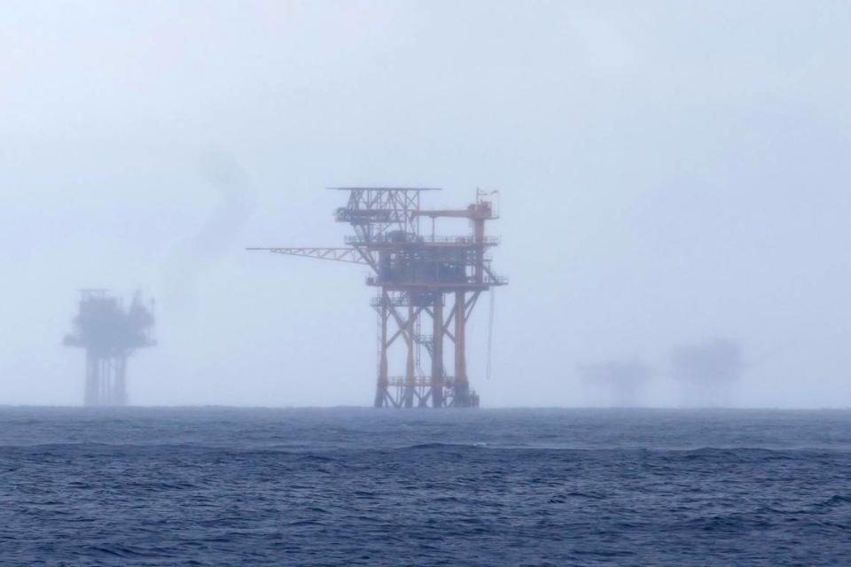 CORRECTS TO 382 MILLION NOT 328 FILE - Oil platforms are visible through the haze near the Flower Garden Banks National Marine Sanctuary in the Gulf of Mexico, off the coast of Galveston, Texas, Sept. 16, 2023. Oil companies offered $382 million for drilling leases in the Gulf Wednesday after courts rejected the Biden administration’s plans to scale back the sale to protect an endangered whale species. (AP Photo/LM Otero, file)