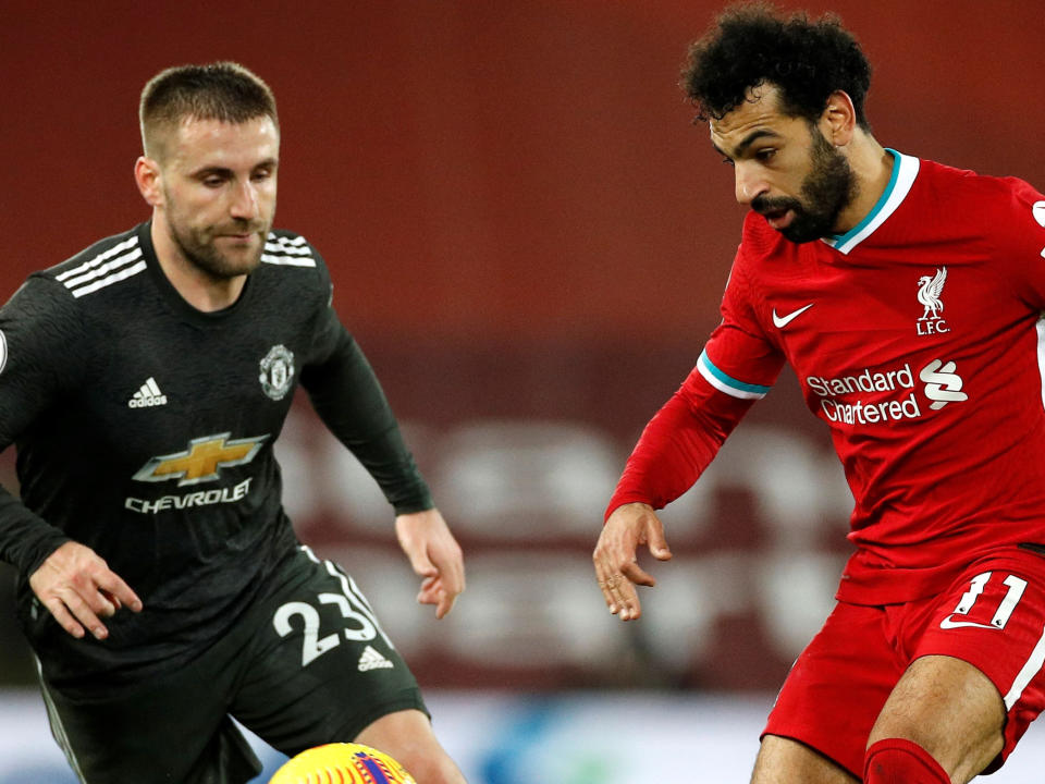 Mohamed Salah takes on Luke ShawPOOL/AFP via Getty Images