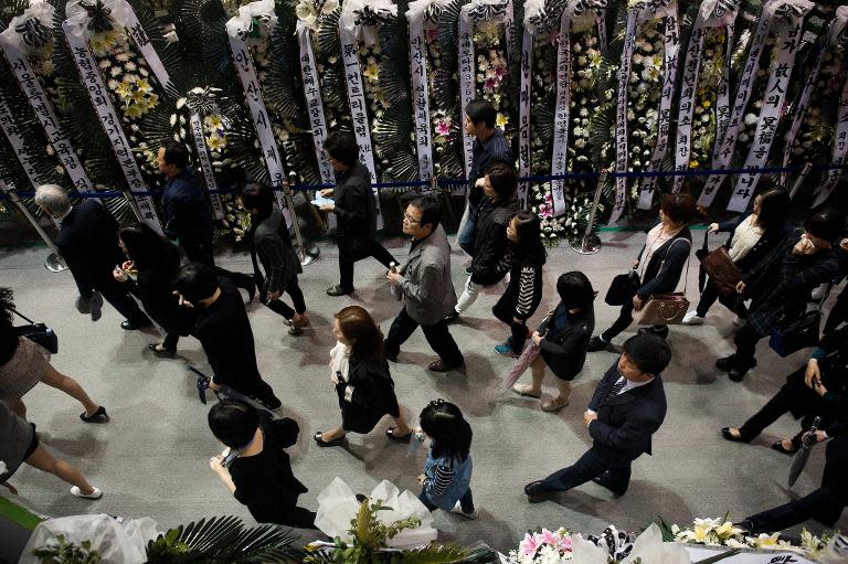 South Korean mourners attend a memorial service for the victims of the sunken "Sewol" ferry at the Olympic memorial hall in Ansan, on April 27, 2014