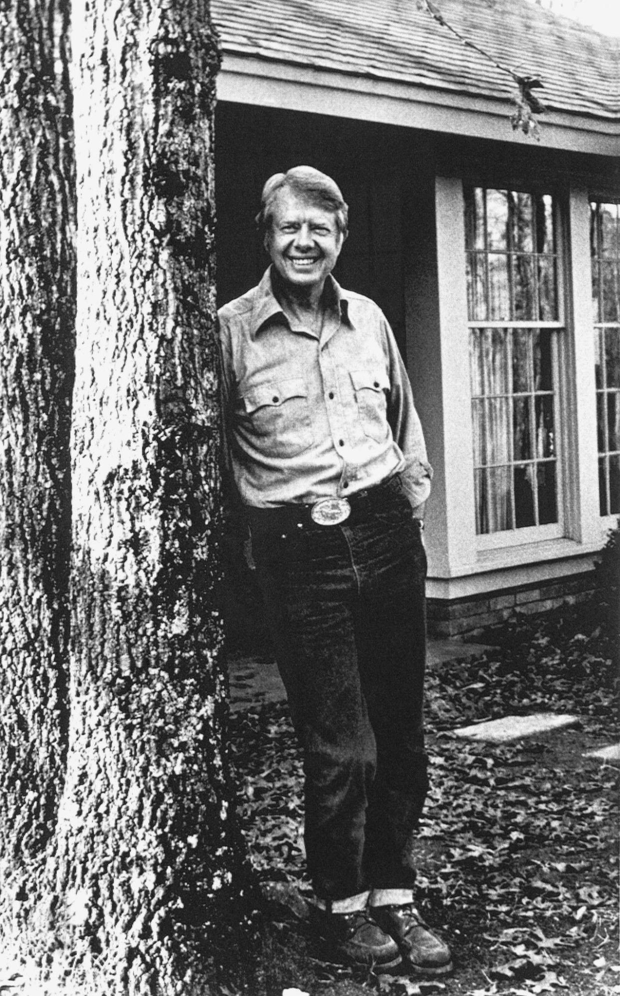 Former Gov. Jimmy Carter relaxes in blue jeans outside his home on Feb. 8, 1976, in Plains, Ga., as he takes a break from campaigning for the Democratic nomination for president.