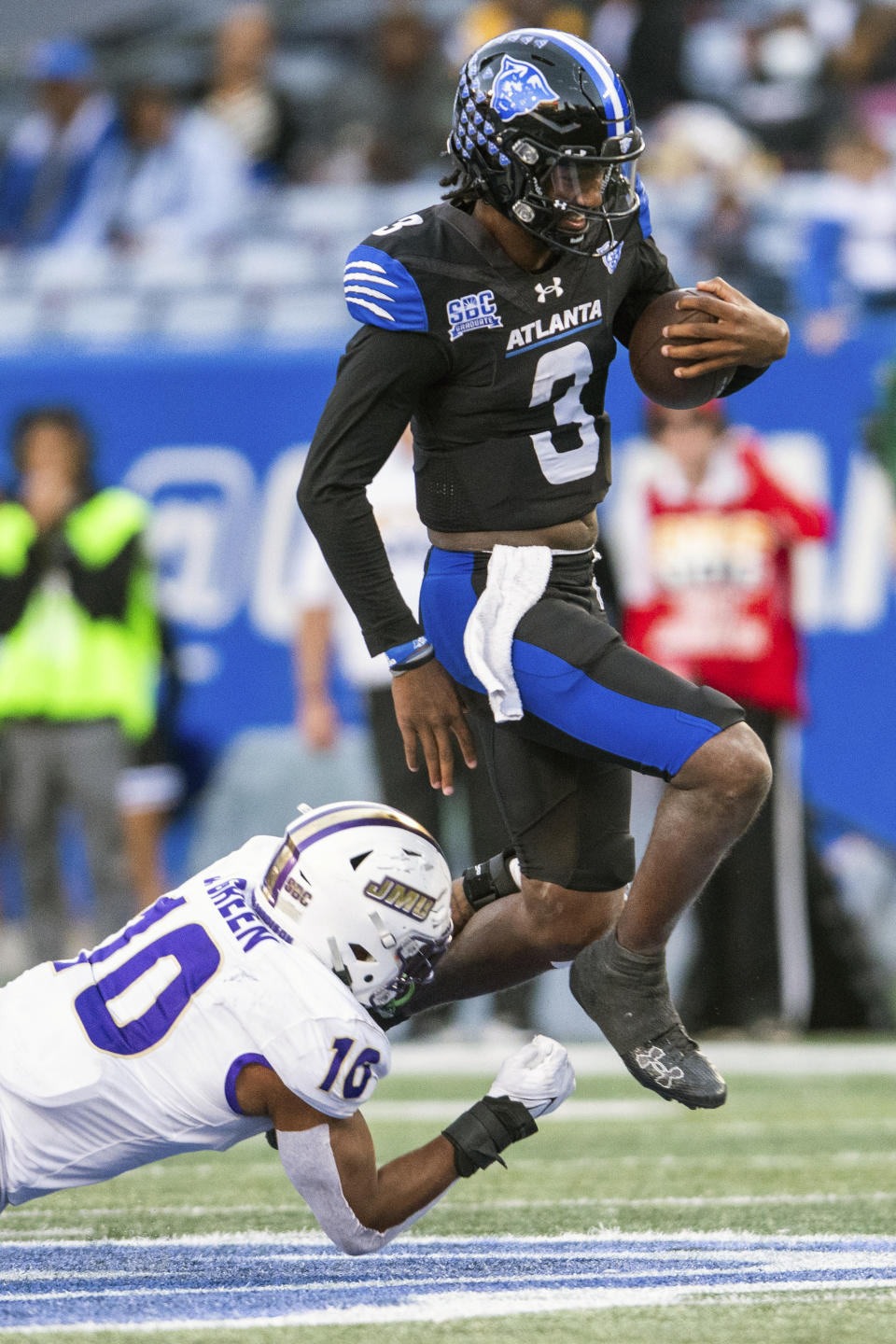 Georgia State quarterback Darren Grainger (3) jumps away from James Madison defensive lineman Jalen Green (10) in the second half of an NCAA college football game Saturday, Nov. 4 2023, in Atlanta. (AP Photo/Hakim Wright Sr.)