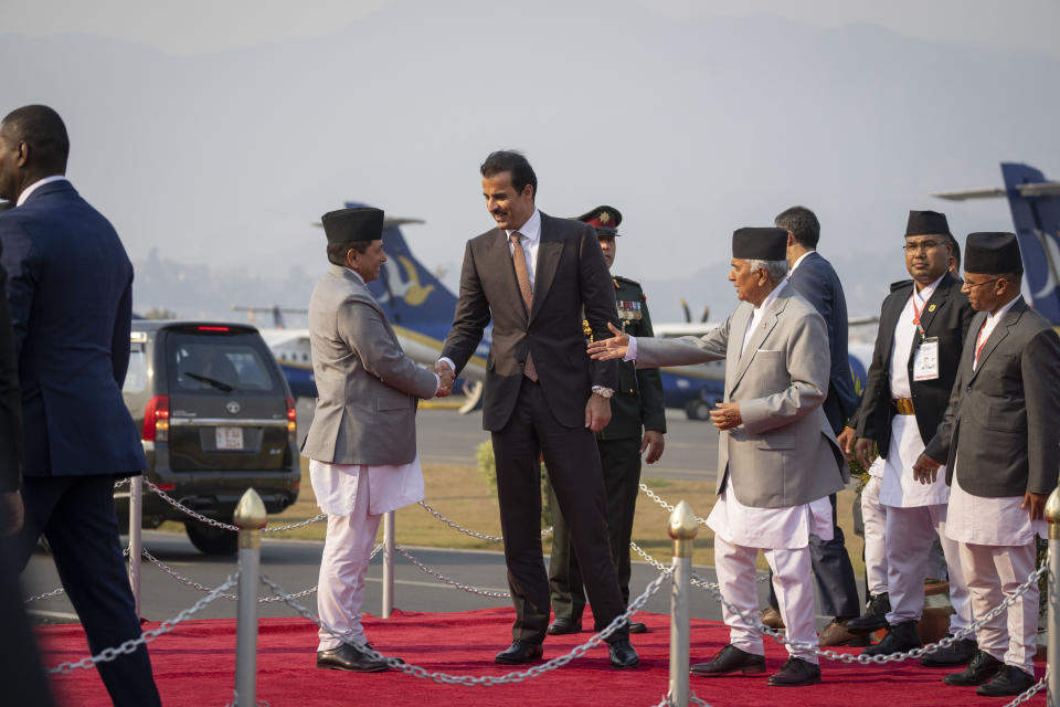 Nepal's president Ram Chandra Poudel, right, introduces Nepal's Minister of Foreign Affairs Narayan Kaji Shrestha to Qatar's Emir Sheikh Tamim bin Hamad Al arrival at Tribhuvan international airport in Kathmandu, Nepal, Tuesday, April 23, 2024. The emir is on a two-days visit to the Himalayan nation. (AP Photo/Niranjan Shreshta)