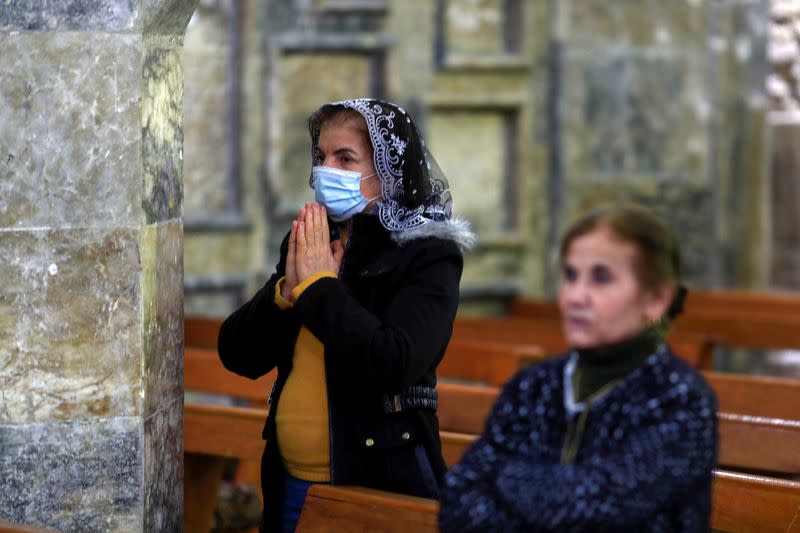 Iraqi Christians attend a mass at the Grand Immaculate old Church in Qaraqosh