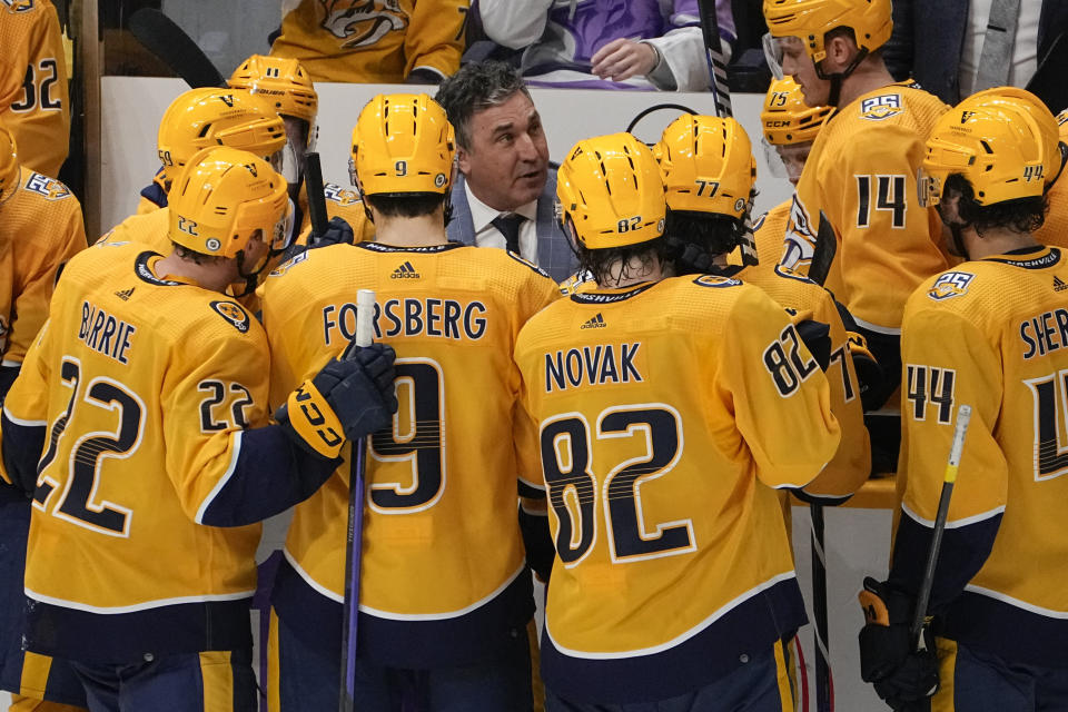 FILE - Nashville Predators head coach Andrew Brunette, center, gives instruction to his players during a timeout in the third period of an NHL hockey game against the Vancouver Canucks, Tuesday, Oct. 24, 2023, in Nashville, Tenn. Vancouver won 3-2. Of the 16 teams entering the NHL playoffs this weekend, seven feature coaches who are in their first full year or hired as midseason replacements.(AP Photo/George Walker IV, File)