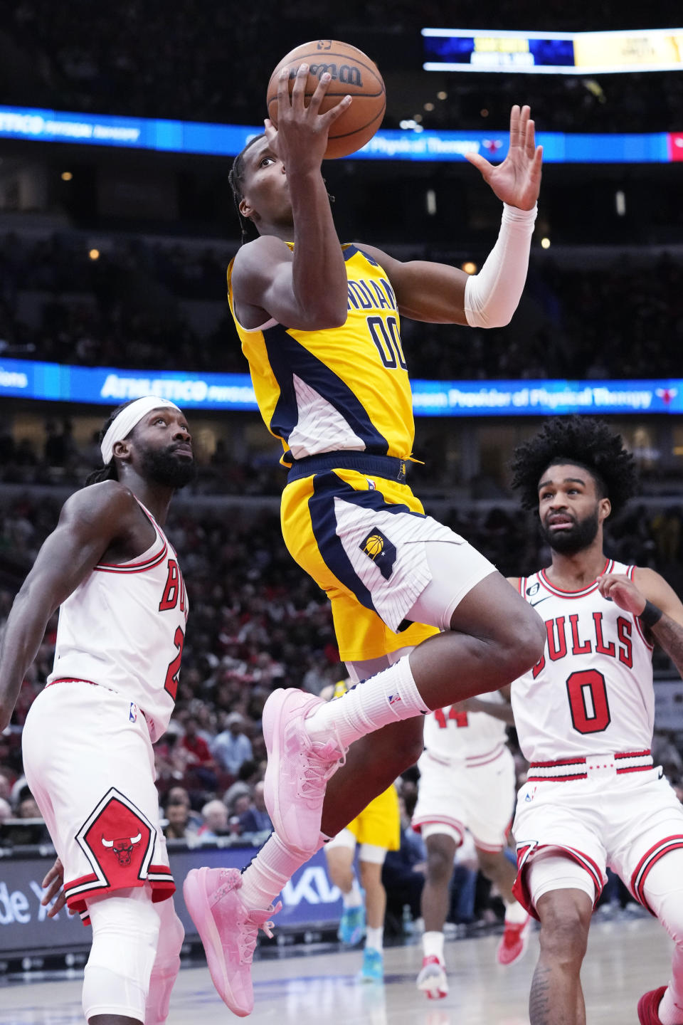 Indiana Pacers guard Bennedict Mathurin, center, drives to the basket past Chicago Bulls guard Patrick Beverley, and guard Coby White during the first half of an NBA basketball game in Chicago, Sunday, March 5, 2023. (AP Photo/Nam Y. Huh)