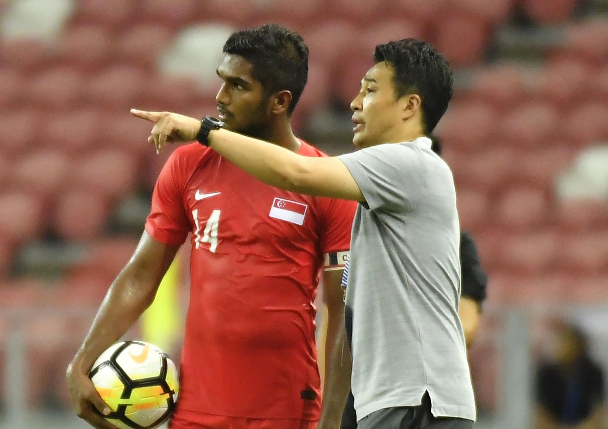 Singapore national football team coach Tatsuma Yoshida with captain Hariss Harun. (PHOTO: PictoBank/Getty Images)