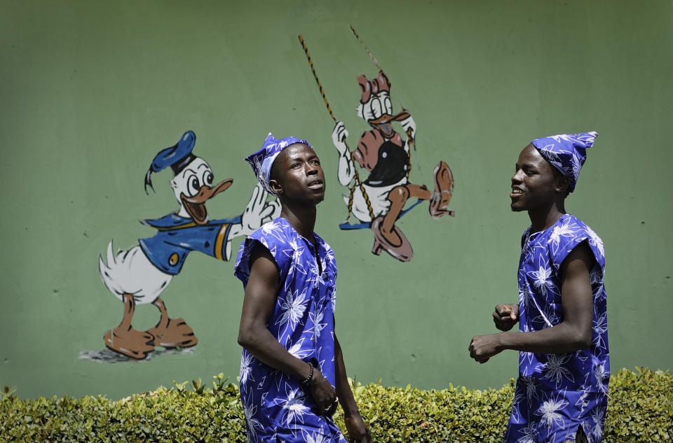 In this photo taken Monday, Feb. 18, 2019, performers record a music video calling for a peaceful election, at a golf resort outside of Kano, northern Nigeria. Faced with an election that could spiral into violence, some in the popular Hausa-language film industry known as Kannywood assembled this week to shoot an urgent music video appealing to the country for peace. (AP Photo/Ben Curtis)