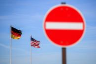 National flags of the U.S. and Germany flutter in the wind near the main gate of the U.S. Spangdahlem Air Base near Bitburg