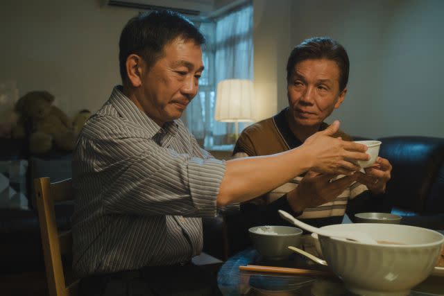 Elderly gay lovers Pak (right) and Hoi share a dinner together in 'Suk Suk'. 