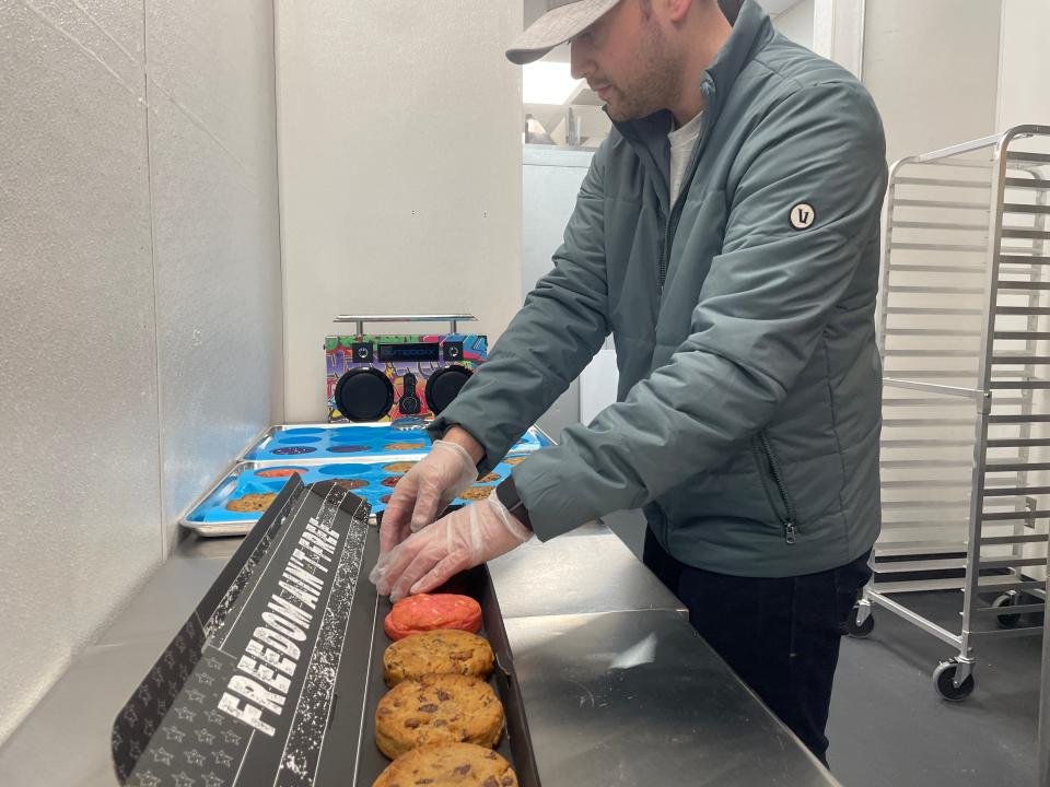 Ricky Hurd assembles a box of cookies at Cookie Plug in Brighton on Tuesday, Feb. 13, 2024.