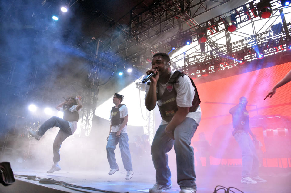 Brockhampton performing at 2018 Coachella, wearing white t-shirts and Black vests.